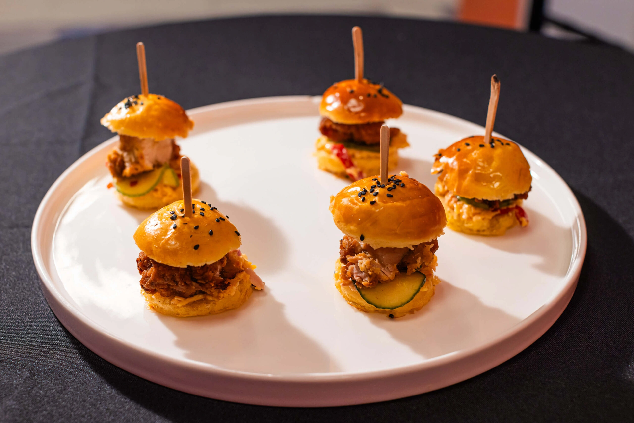 Bite-sized burgers are served at an event at Museum of Illusions.
