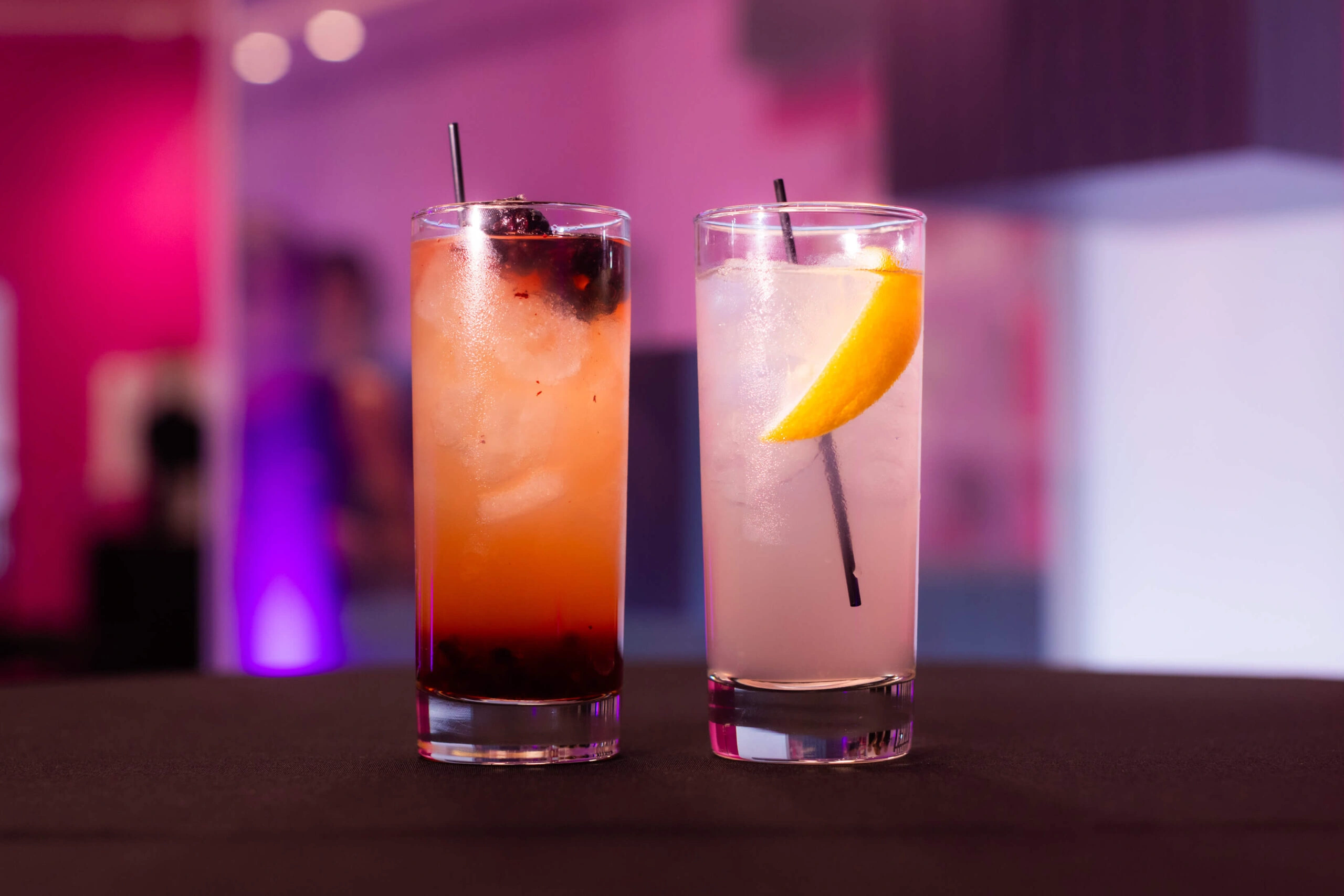 Two cocktails - one with raspberries, the other one with lemon, are served at a party at Museum of Illusions.